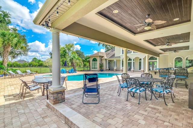 view of patio / terrace featuring ceiling fan and a fenced in pool