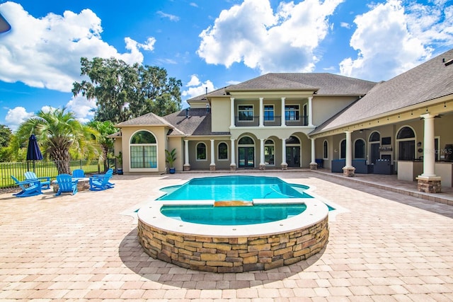 view of swimming pool featuring an in ground hot tub and a patio area