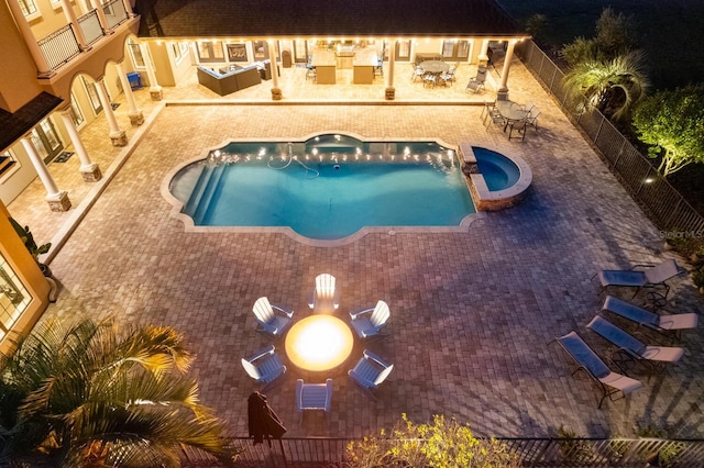 view of pool with an in ground hot tub and a patio