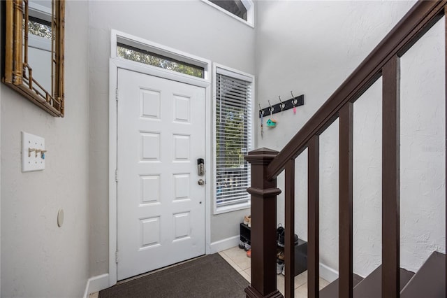 tiled foyer entrance with a wealth of natural light