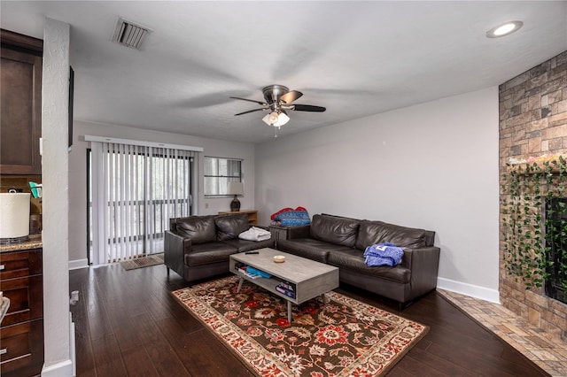 living room featuring dark hardwood / wood-style floors and ceiling fan