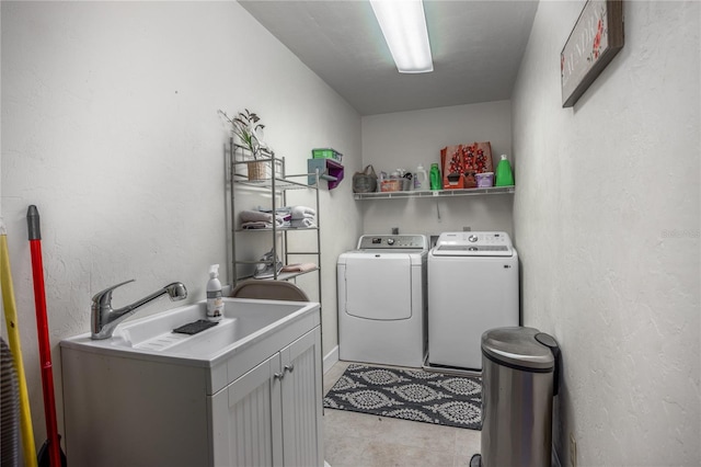 laundry room featuring washer and dryer and cabinets