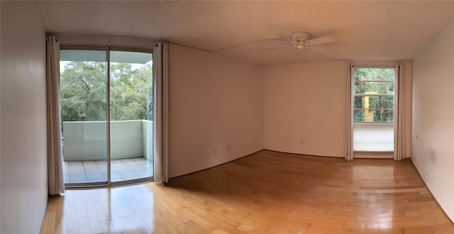 unfurnished room with light hardwood / wood-style flooring, a textured ceiling, and ceiling fan