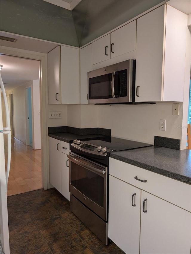 kitchen featuring appliances with stainless steel finishes and white cabinetry