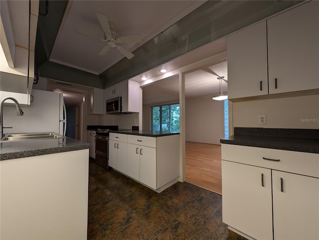 kitchen featuring ceiling fan, white cabinetry, range, sink, and white refrigerator