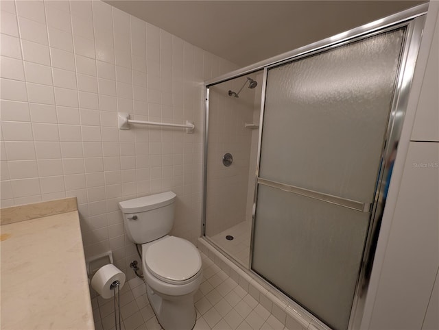 bathroom featuring toilet, walk in shower, tile patterned flooring, and tile walls