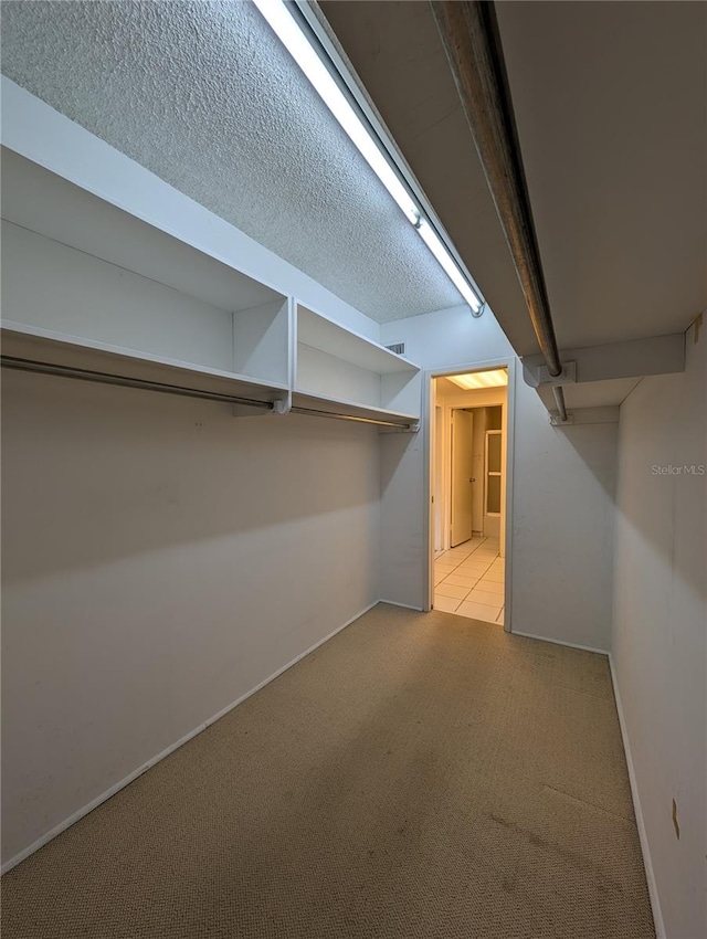 basement with a textured ceiling and light colored carpet