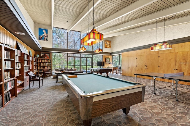 rec room featuring wood walls, beamed ceiling, a high ceiling, and pool table