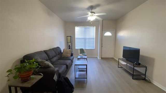 living room with light wood-type flooring and ceiling fan