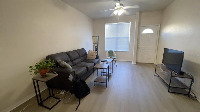 living room featuring light hardwood / wood-style flooring and ceiling fan