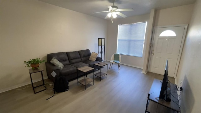 living room featuring light hardwood / wood-style flooring and ceiling fan