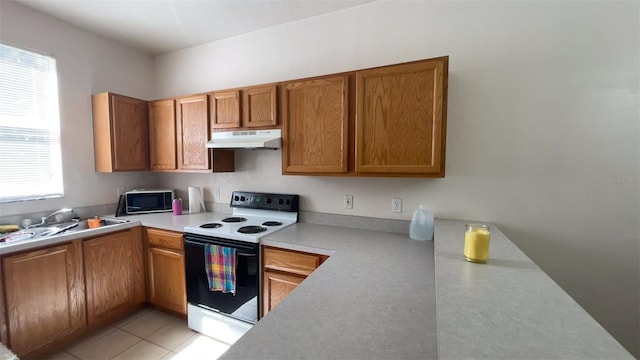 kitchen with sink, light tile patterned floors, and white electric stove