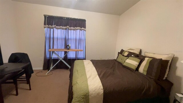 carpeted bedroom with vaulted ceiling