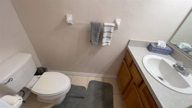 bathroom with vanity, toilet, and tile patterned floors