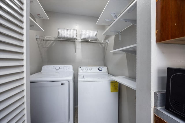 laundry area featuring washing machine and clothes dryer