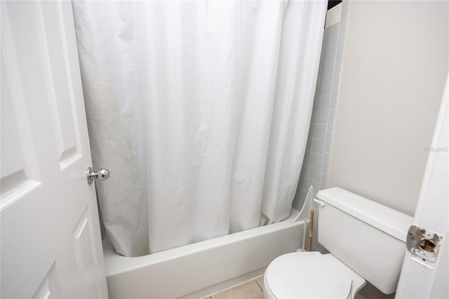 bathroom featuring shower / bath combo, toilet, and tile patterned flooring