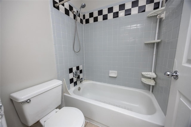 bathroom featuring toilet and tiled shower / bath combo