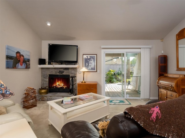 living room with light carpet, a stone fireplace, and lofted ceiling