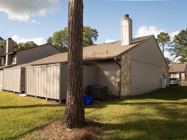 back of property featuring a lawn