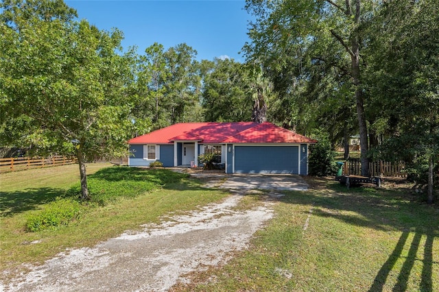 single story home with a front yard and a garage