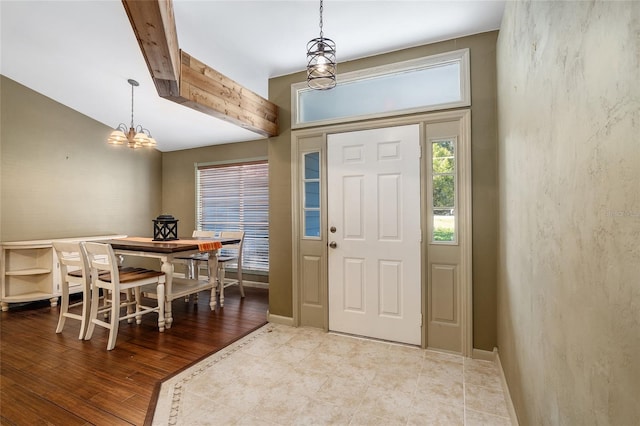 entryway with a notable chandelier and light wood-type flooring