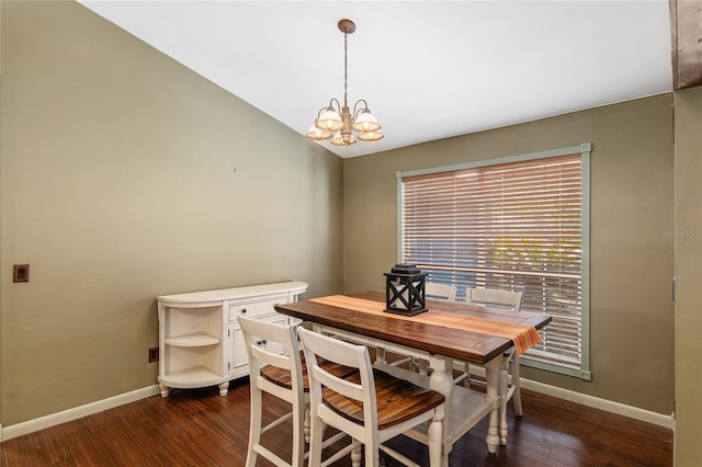 dining space featuring lofted ceiling, an inviting chandelier, and dark hardwood / wood-style floors