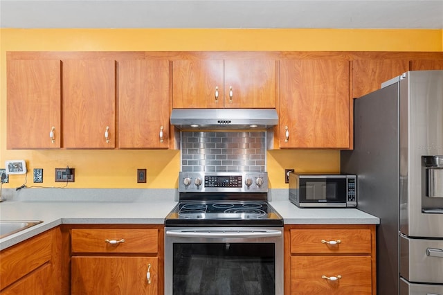 kitchen with stainless steel appliances and tasteful backsplash