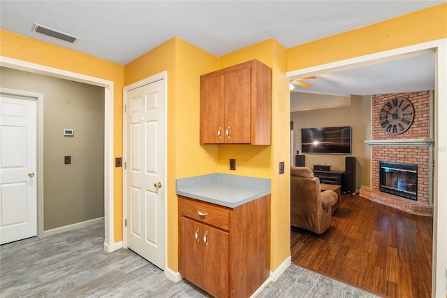 kitchen featuring light hardwood / wood-style flooring and a fireplace