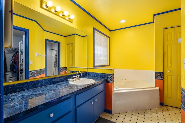 bathroom with vanity and a relaxing tiled tub