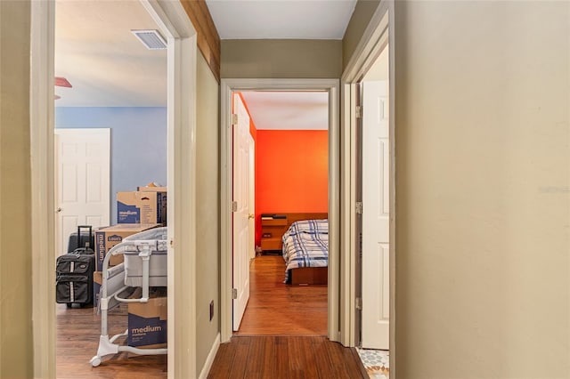 hall with hardwood / wood-style floors