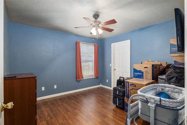 office with dark wood-type flooring and ceiling fan