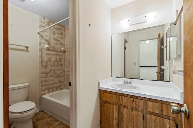 full bathroom featuring vanity, toilet, tiled shower / bath combo, and tile patterned flooring