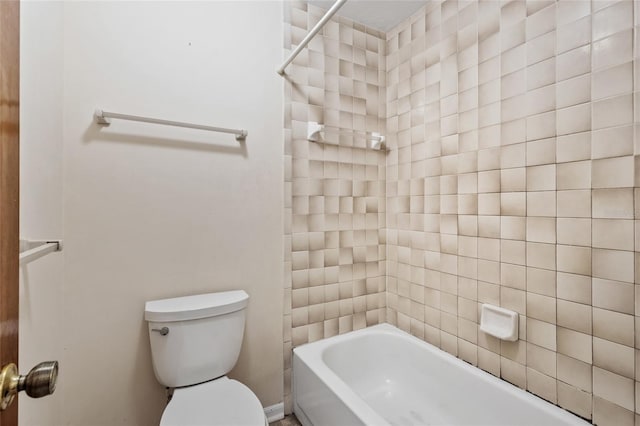 bathroom featuring toilet and tiled shower / bath combo