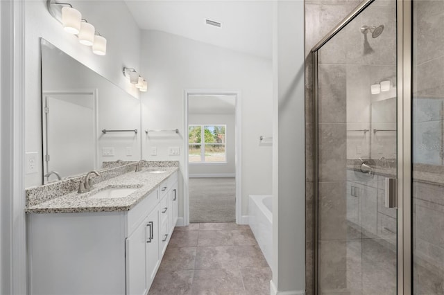 bathroom with vanity, lofted ceiling, separate shower and tub, and tile patterned floors