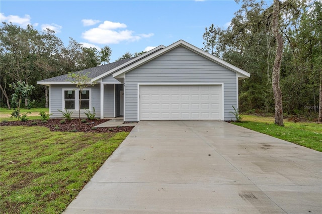 ranch-style house featuring a garage and a front lawn