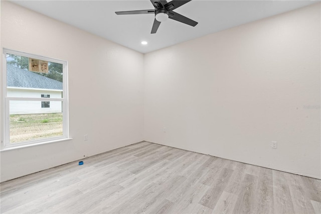 spare room featuring light hardwood / wood-style flooring and ceiling fan