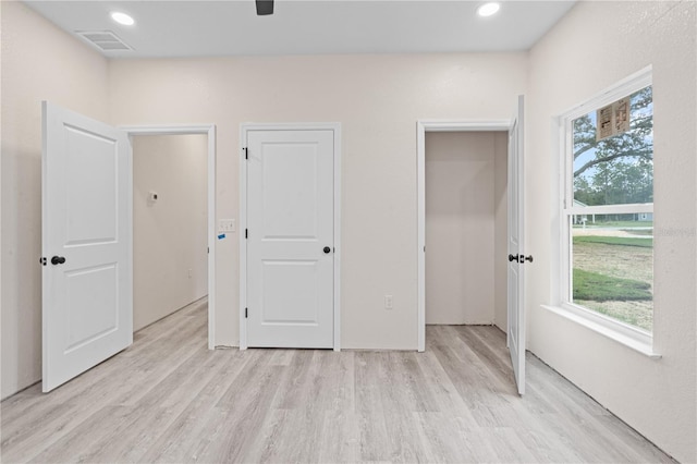 unfurnished bedroom with light wood-type flooring and ceiling fan