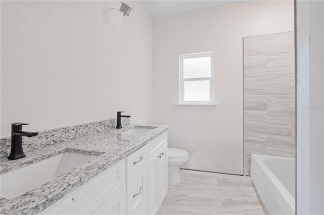 bathroom with a bathtub, toilet, and vanity