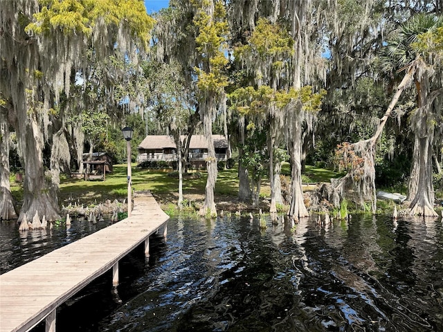 view of dock with a gazebo and a water view