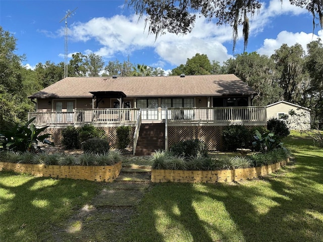 back of property featuring a yard and a deck