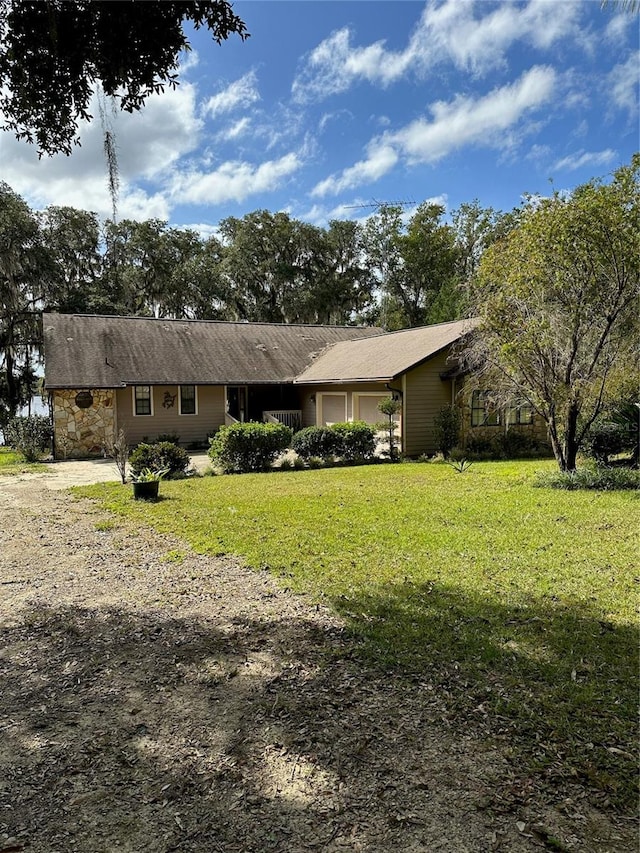 ranch-style house with a front lawn