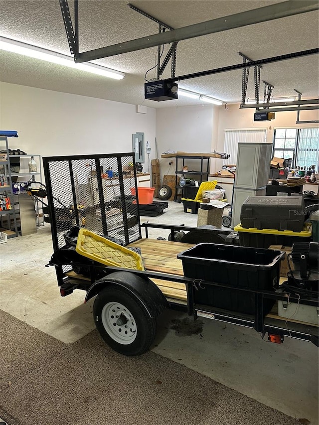 garage with electric panel and a garage door opener