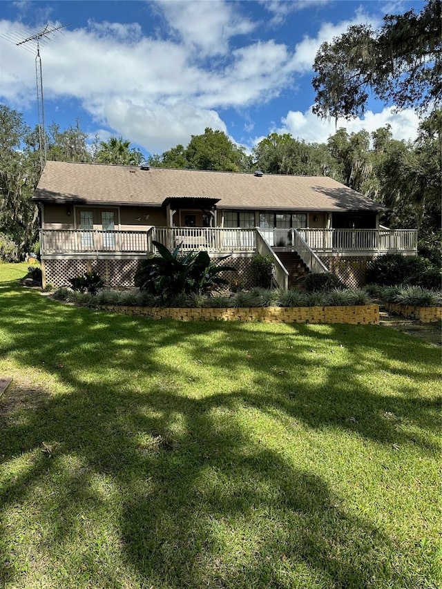 view of front facade featuring a wooden deck and a front lawn