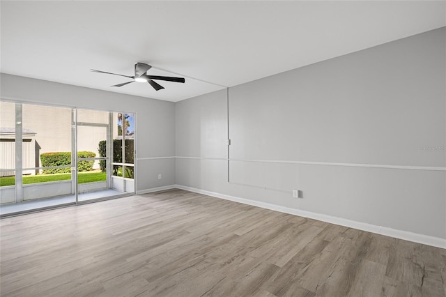 unfurnished room with baseboards, ceiling fan, and wood finished floors