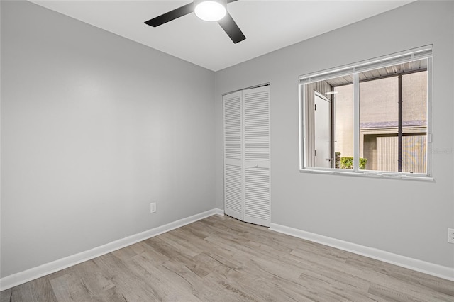 unfurnished bedroom featuring light hardwood / wood-style floors, a closet, and ceiling fan