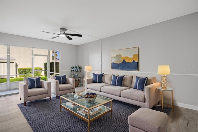 living room with wood-type flooring and ceiling fan