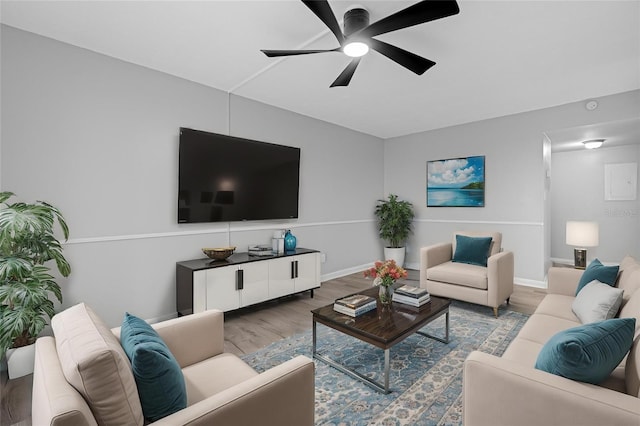 living room with wood-type flooring and ceiling fan