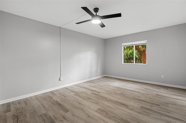 spare room with light hardwood / wood-style flooring and ceiling fan