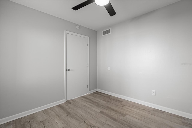 empty room with ceiling fan and light wood-type flooring