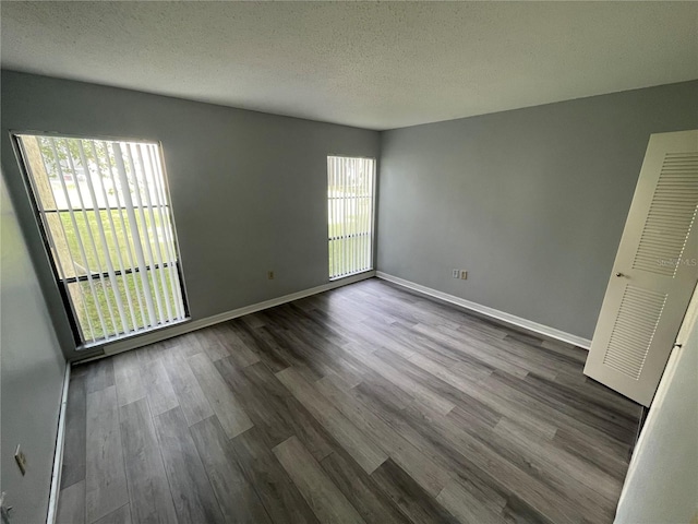 empty room featuring a textured ceiling and hardwood / wood-style flooring